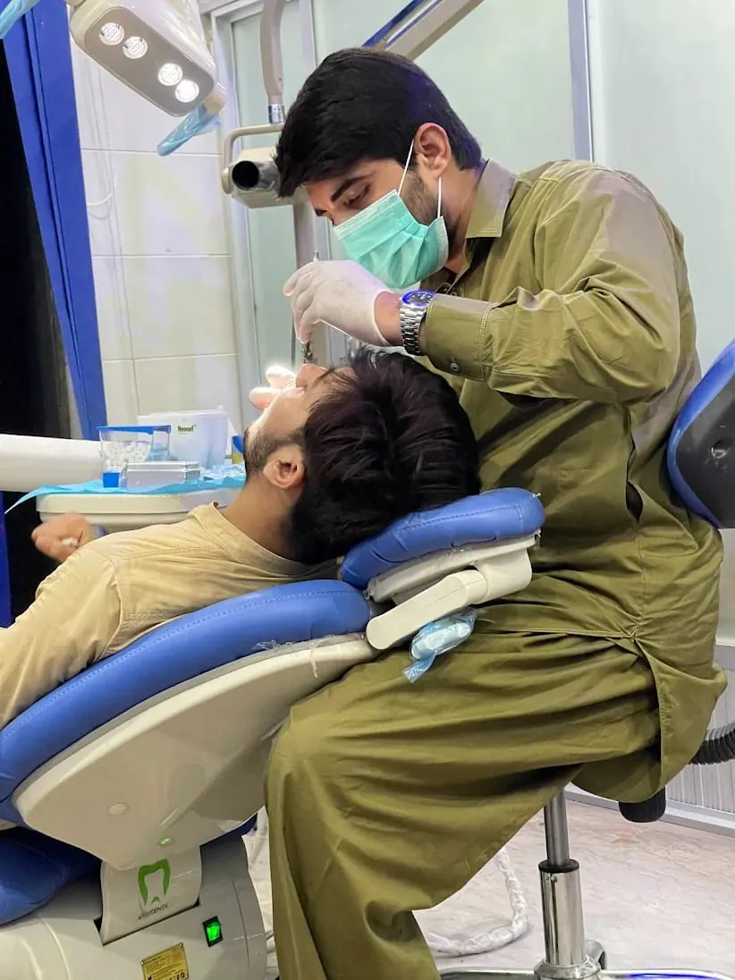 Dentist performing a root canal examination on a patient in the dental chair